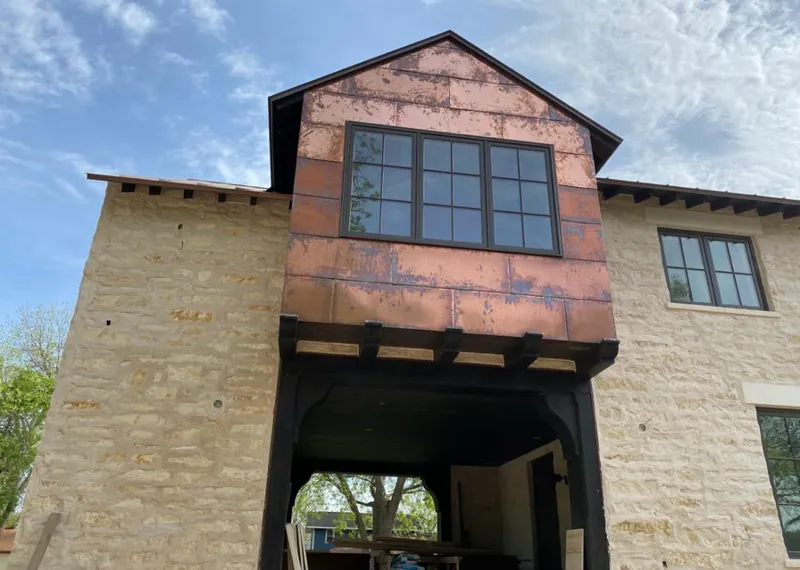 Copper metal panel facade on a stone building for Skylight Installation in Lake Alfred