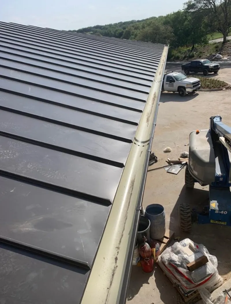 Standing seam panel and gutter detail on a metal roofing jobsite in Lake Alfred